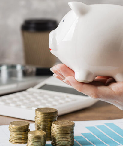hand-holding-piggy-bank-with-growth-chart-coins